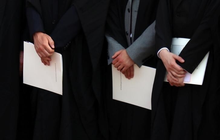 Warwick University graduates hold their degree certificates on the day of their graduation ceremony in Warwick, Britain July 17, 2017. Picture taken July 17, 2017. REUTERS/Russell Boyce