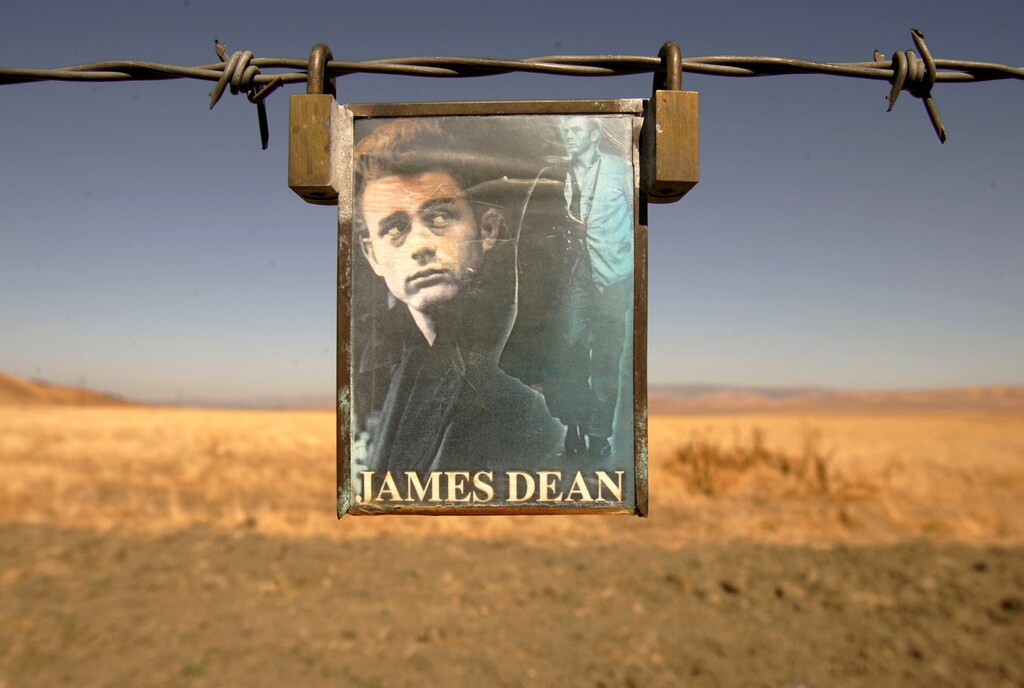 A portrait of U.S. actor James Dean hangs from a fence near the intersection of Highways 46 and 41 near Cholame, California September 30, 2005.