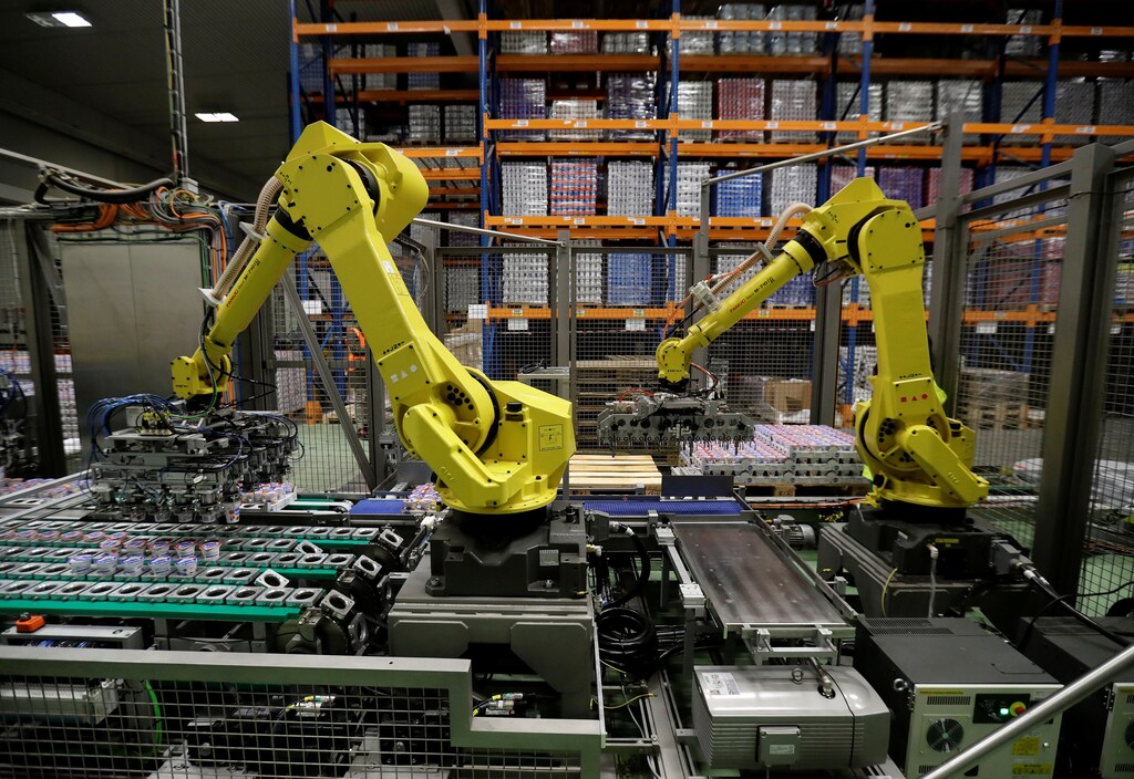 Robotic arms sort and load yogurts onto pallets at a distribution centre near Prague, Czech Republic, February 17, 2020. Picture taken February 17, 2020. REUTERS/David W Cerny - RC29GF93GWJK