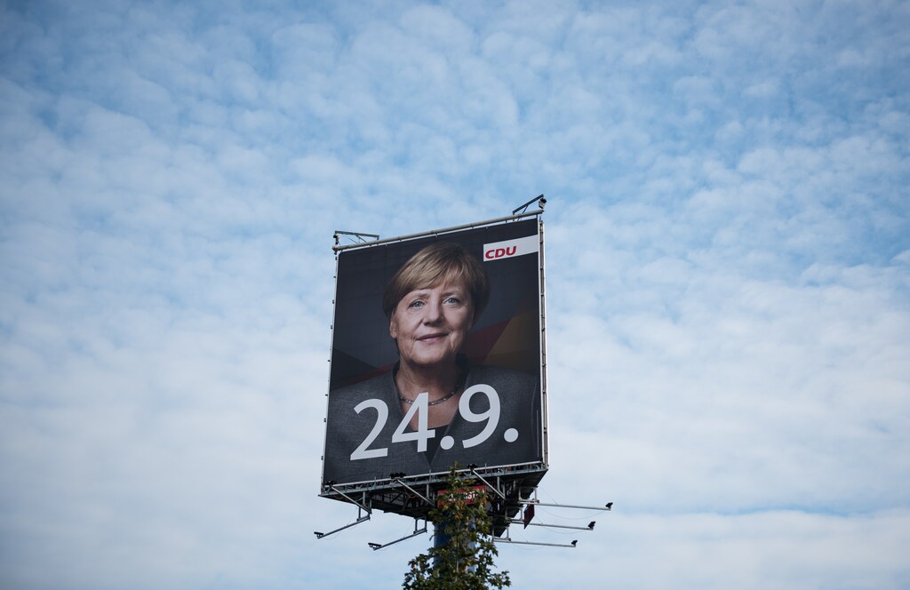 An election campaign poster for the upcoming general elections of the Christian Democratic Union party (CDU) with a headshot of German Chancellor Angela Merkel is displayed in Wustermark near Berlin, Germany, September 20, 2017. REUTERS/Stefanie Loos - RC1577380D80