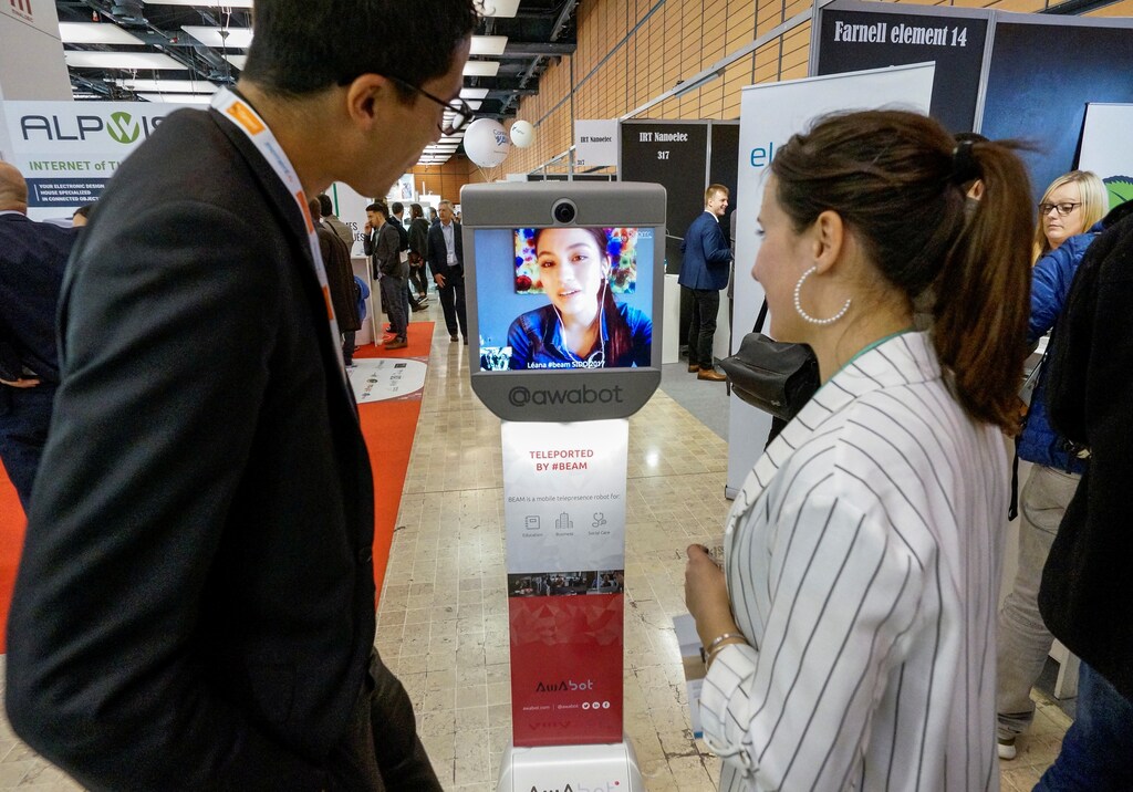 Visitors look at a Beam mobile telepresence robot by Awabot at the SIdO, the Connected Business trade show, in Lyon, France, April 6, 2017