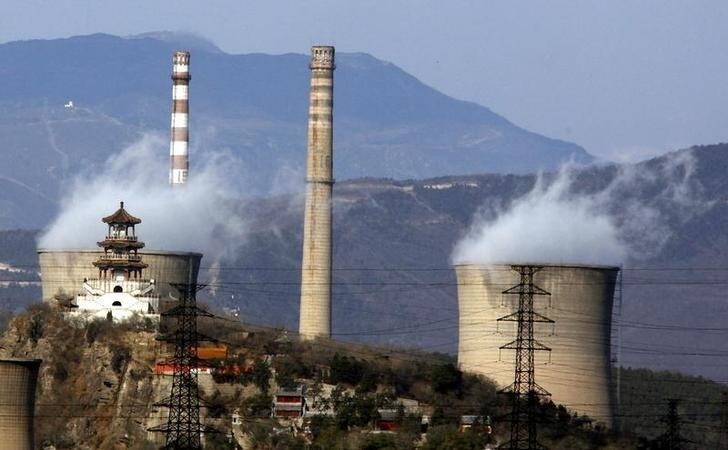 A traditional Chinese pagoda stands atop a hill near chimneys of a coal-burning power station located on the outskirts of Beijing November 22, 2011. Economic problems in Europe and elsewhere should not get in the way of a new pact to reduce global warming and slash greenhouse gas emissions, China's top climate official said on Tuesday ahead of the latest round of negotiations beginning in South Africa next week where delegates from nearly 200 countries will meet for climate talks. With global carbon emissions rising by a record amount last year, rebounding on the heels of recession, the United Nations, the International Energy Agency and others say global pledges to curb emissions of CO2 and other greenhouse gases are not enough to prevent the planet heating up beyond 2 degrees Celsius. REUTERS/David Gray (CHINA - Tags: ENVIRONMENT POLITICS)