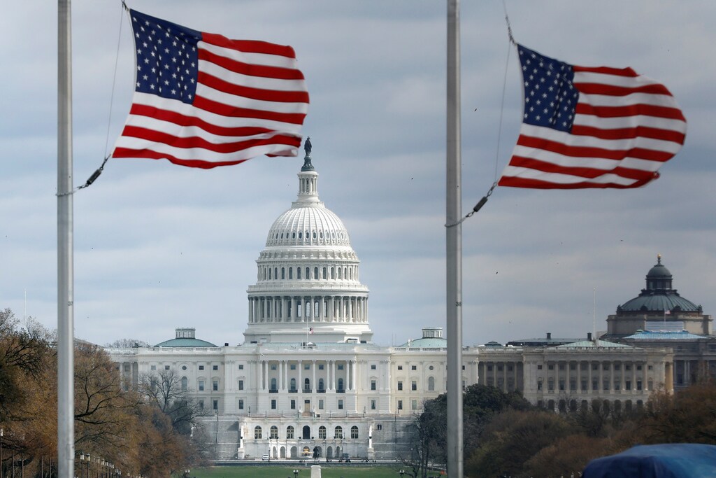 American flags fly on National Mall with U.S. Capitol on background as high-wind weather conditions continue in Washington, U.S. March 2, 2018. REUTERS/Yuri Gripas - RC1F0AB16100