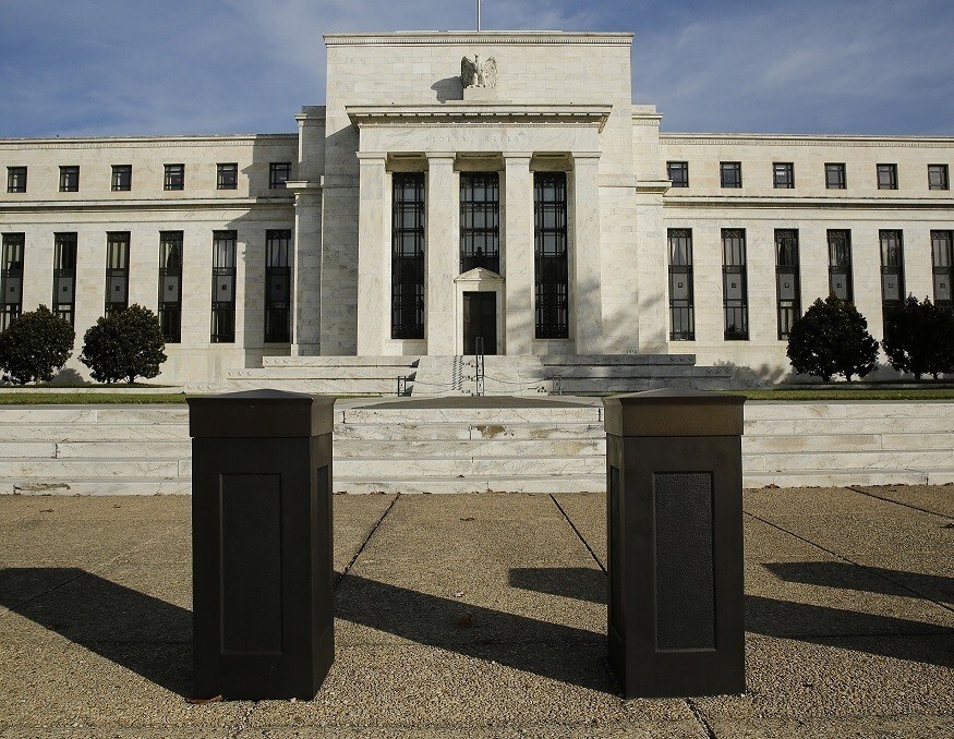 The United States Federal Reserve Board building is shown behind security barriers in Washington October 28, 2014. The U.S. Federal Reserve this week will likely reinforce its stated willingness to wait a long while before hiking interest rates after a volatile month in financial markets that saw some measure of inflation expectations drop worryingly low. REUTERS/Gary Cameron (UNITED STATES - Tags: BUSINESS POLITICS) - RTR4BX4X