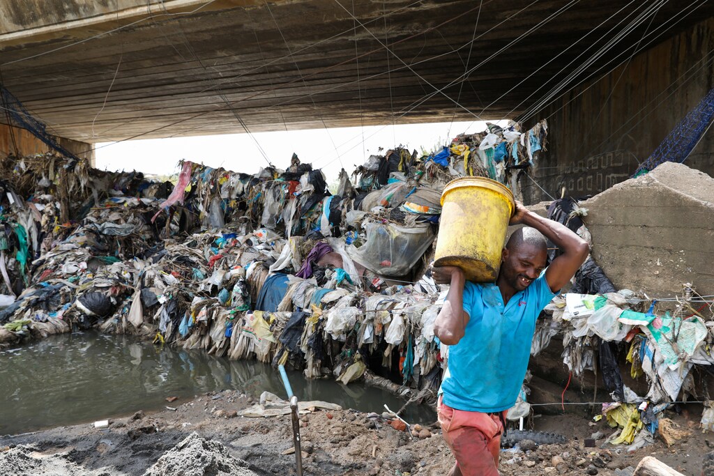 A man collects recyclable plastic in Olifantsfontein near Kempton Park, South Africa
