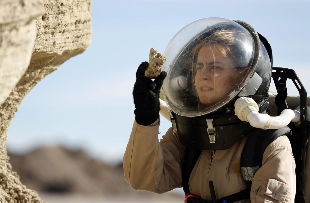 Csilla Orgel, a geologist with Crew 125 EuroMoonMars B mission, collects geologic samples for study at the Mars Desert Research Station (MDRS) outside Hanksville in the Utah desert March 2, 2013. The MDRS aims to investigate the feasibility of a human exploration of Mars and uses the Utah desert's Mars-like terrain to simulate working conditions on the red planet. Scientists, students and enthusiasts work together developing field tactics and studying the terrain. All outdoor exploration is done wearing simulated spacesuits and carrying air supply packs and crews live together in a small communication base with limited amounts of electricity, food, oxygen and water. Everything needed to survive must be produced, fixed and replaced on site. Picture taken March 2, 2013. REUTERS/Jim Urquhart (UNITED STATES - Tags: SCIENCE TECHNOLOGY SOCIETY ENVIRONMENT)ATTENTION EDITORS: PICTURE 22 OF 31 FOR PACKAGE 'MARS IN THE DESERT'SEARCH 'JIM MARS' FOR ALL IMAGES - RTR3EUHW