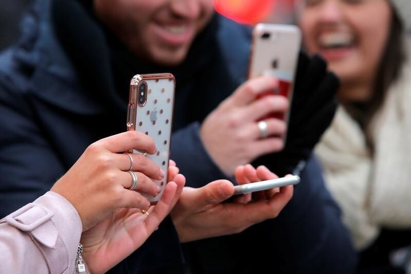 People use their cell phones in Times Square in Manhattan, New York, U.S., January 30, 2018.