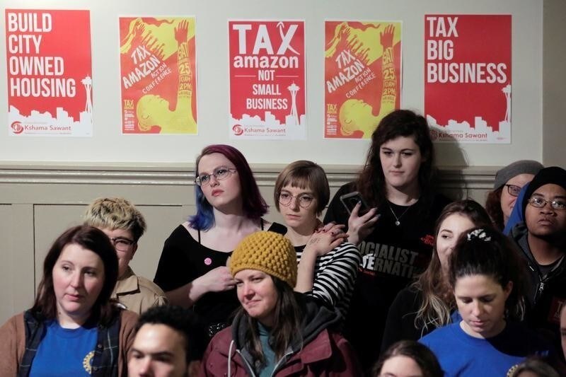 Supporters listen as Socialist Seattle City Council member Kshama Sawant restarts the "Tax Amazon" campaign she led in 2019 with a rally at Washington Hall in Seattle, Washington, U.S. January 13, 2020. REUTERS/David Ryder - RC2IFE9XKO8N