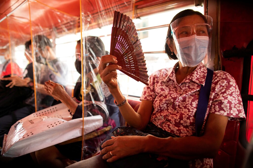 Jeepney passengers seated in between plastic barriers, wear face masks and face shields mandatory in public transportation, to help curb coronavirus disease (COVID-19) infections, in Quezon City, Metro Manila, Philippines, August 19, 2020. REUTERS/Eloisa Lopez TPX IMAGES OF THE DAY - RC2WGI96KVEU