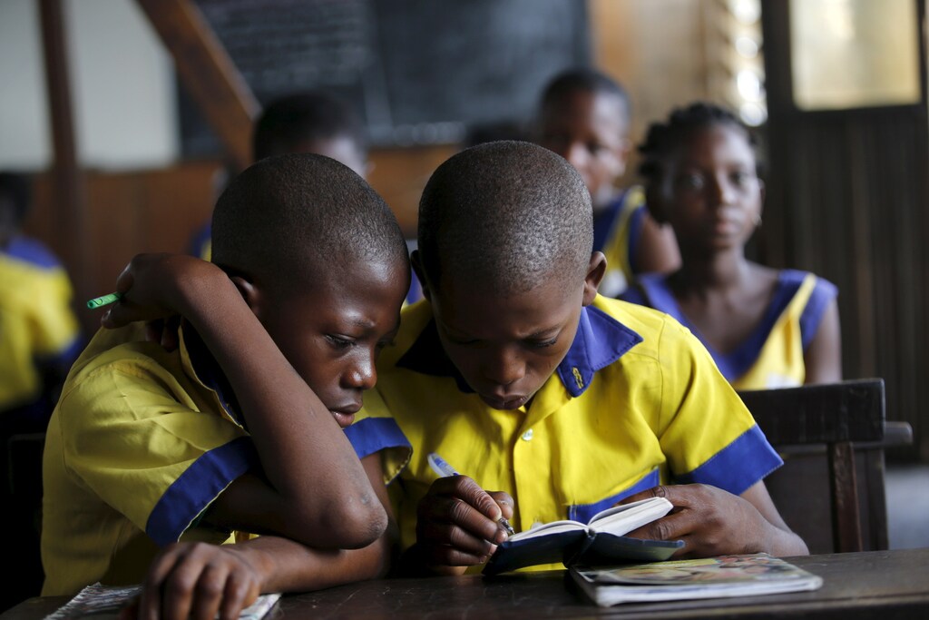 Students read a book at the Makoko floating school on the Lagos Lagoon, Nigeria February 29, 2016. In Makoko, a sprawling slum of Nigeria's megacity Lagos, a floating school capable of holding up to a hundred pupils has since November brought free education to the waterways known as the Venice of Lagos. It offers the chance of social mobility for youngsters who, like most of the city's 21 million inhabitants, lack a reliable electricity and water supply and whose water-based way of life is threatened by climate change as well as rapid urbanisation. REUTERS/Akintunde Akinleye SEARCH "THE WIDER IMAGE" FOR ALL STORIES - GF10000333183