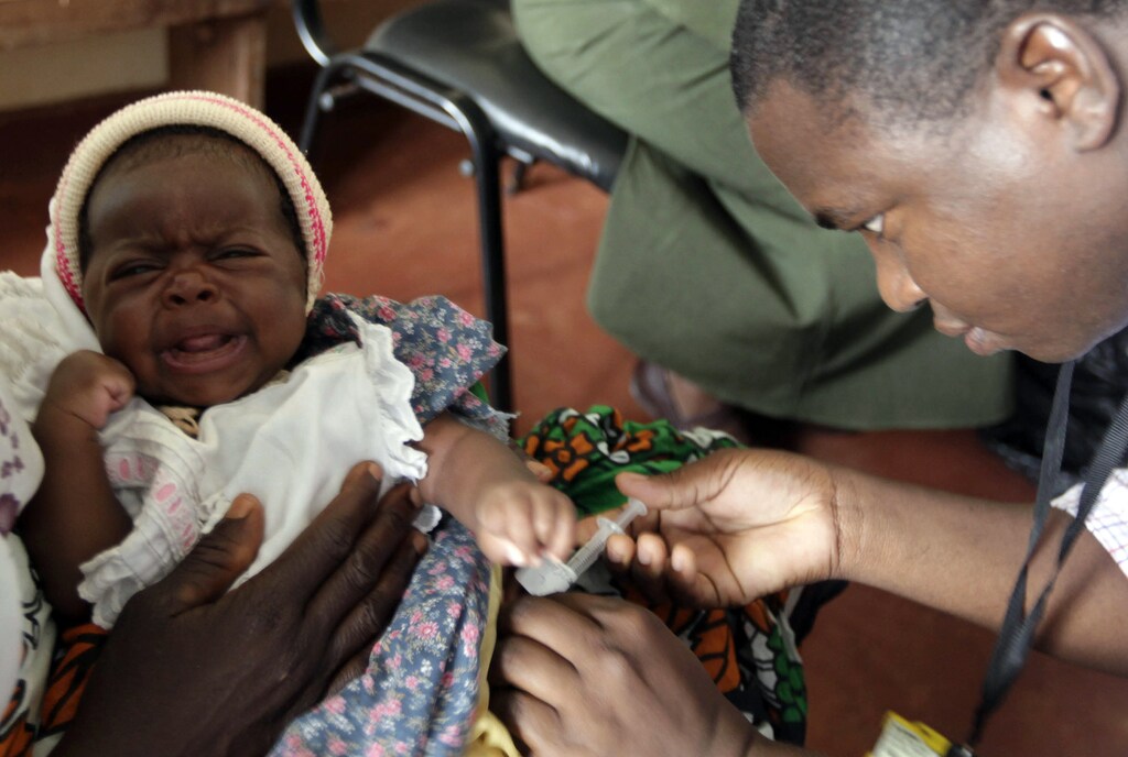 A child is given an injection as part of a malaria vaccine trial at a clinic in the Kenya coastal town of Kilifi, November 23, 2010. Malaria threatens half the people on the planet and kills around 800,000 people a year, many of them too young to have even learned to walk. The death rate has come down in the last decade, but full-scale eradication will cost billions and drag funds away from other equally, or possibly even more urgent health efforts. As governments in poor countries and donors from wealthy ones weigh up where to put their money, experts have begun a quiet but fundamental debate about whether wiping out malaria is realistic or even makes economic sense.