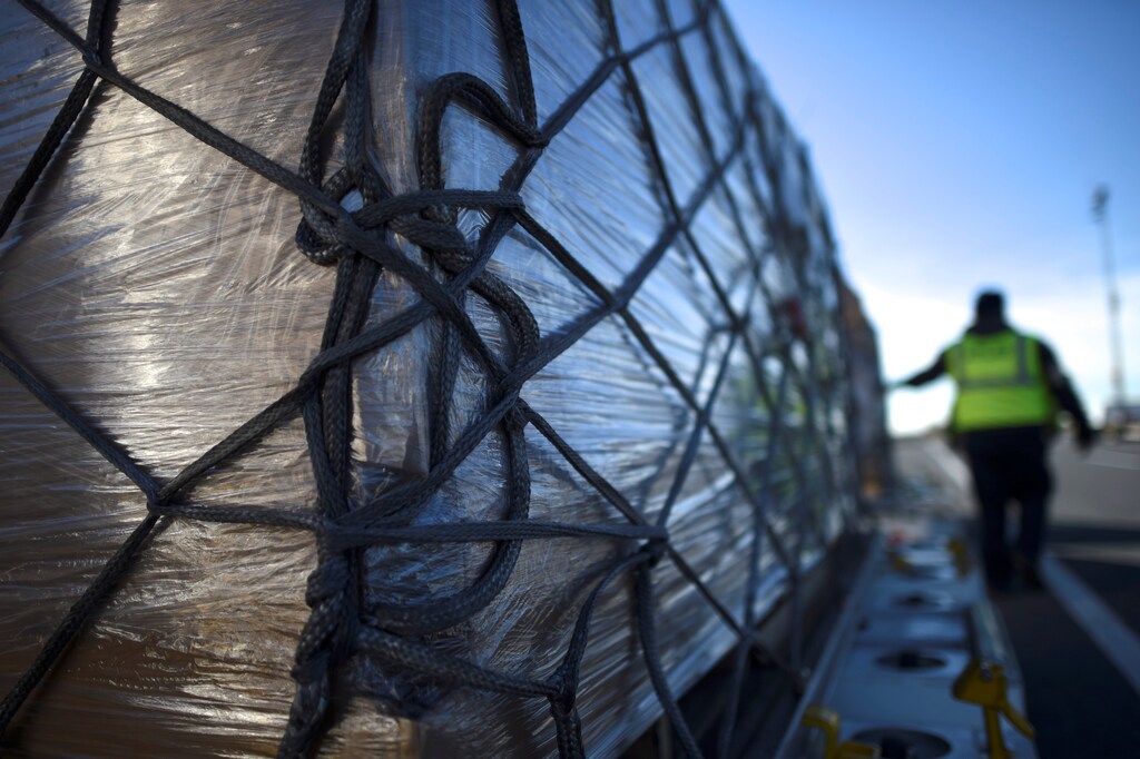 A worker tests the rope tightness while unloading a wide body aircraft emblazoned with Amazon's Prime logo at Lehigh Valley International Airport in Allentown, Pennsylvania, U.S. December 20, 2016. Picture taken December 20, 2016. To match Insight AMAZON.COM-SHIPPING/ REUTERS/Mark Makela - RTX2WAQQ
