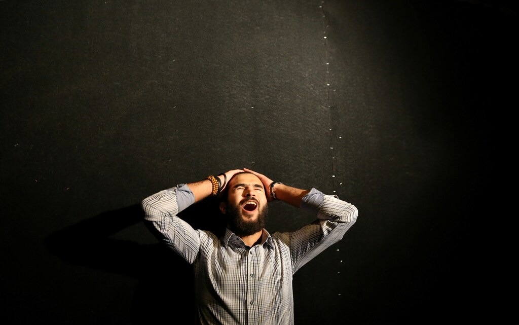 Ahmed Sharaf screams in a dark, soundproof room in an effort to relieve his frustrations and escape from the stresses of daily life in the new "scream room" inside a bookshop in Cairo, Egypt October 23, 2016. Picture taken October 23, 2016. REUTERS/Mohamed Abd El Ghany - RTX2QE7S