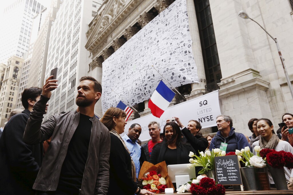 Jack Dorsey (L), CEO of Square and CEO of Twitter, live casts video while standing outside the New York Stock Exchange for the IPO of Square Inc., in New York November 19, 2015. Square Inc priced shares at $9 for its initial public offering, about 25 percent less than it had hoped, as it struggled to win over investors skeptical about its business and valuation before trading begins on Thursday. REUTERS/Lucas Jackson TPX IMAGES OF THE DAY - RTS7YY1