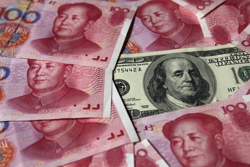 A U.S. $100 banknote is placed next to 100 yuan banknotes in this picture illustration taken in Beijing October 16, 2010. The United States fired the first shot in the currency war and the rest of the world must be on guard for its deliberate strategy to devalue the dollar, a Chinese economist said in an official newspaper on Thursday. REUTERS/Petar Kujundzic (CHINA - Tags: BUSINESS IMAGES OF THE DAY) - GM1E6AG0V7A01