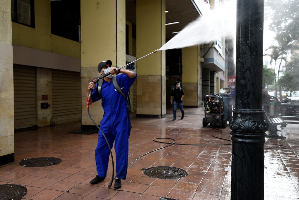 A municipal worker cleans with a power washer after Ecuador's government restricted travel within the country and declared a nighttime curfew as a response to curb the spread of the coronavirus disease (COVID-19), in Guayaquil, Ecuador March 17, 2020.