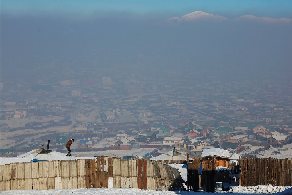 A man walks on the roof of a traditional ger home while fixing the chimney of a coal burning stove on a cold hazy day on the outskirts of Ulaanbaatar, Mongolia January 19, 2017. REUTERS/B. Rentsendorj SEARCH "RENTSENDORJ POLLUTION" FOR THIS STORY. SEARCH "WIDER IMAGE" FOR ALL STORIES. TPX IMAGES OF THE DAY - RC173A927F20