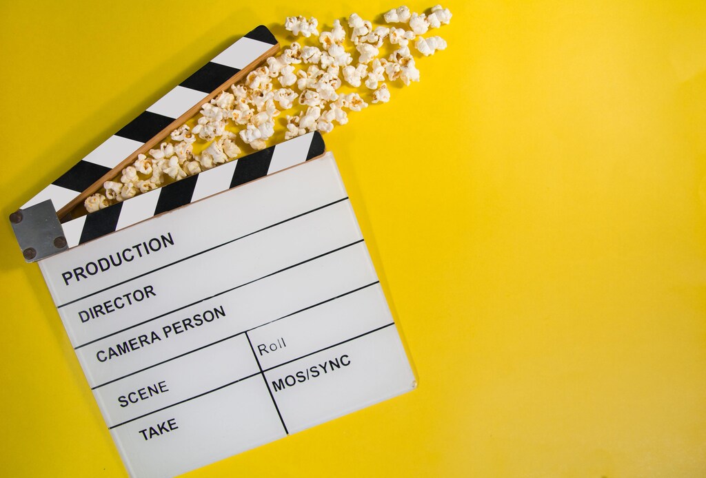 A clapperboard and popcorn.