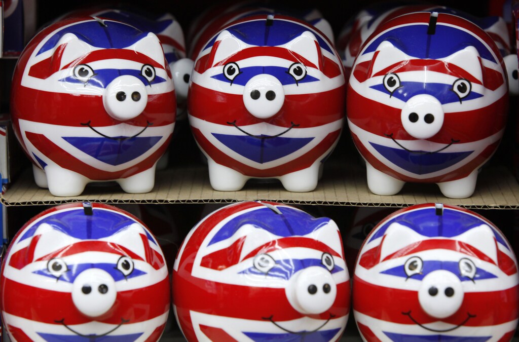 A row of piggy banks adorned with the colours of Britain's Union Jack flag are displayed in a souvenir shop in London March 24, 2010. Britain's Labour government set the stage on Wednesday for a looming election with a budget that promised a 2.5 billion pounds ($3.75 billion) package to boost growth, higher taxes for the well-off and lower borrowing than predicted only three months ago. REUTERS/Darrin Zammit Lupi (BRITAIN - Tags: BUSINESS POLITICS ELECTIONS IMAGES OF THE DAY) - GM1E63P02R401