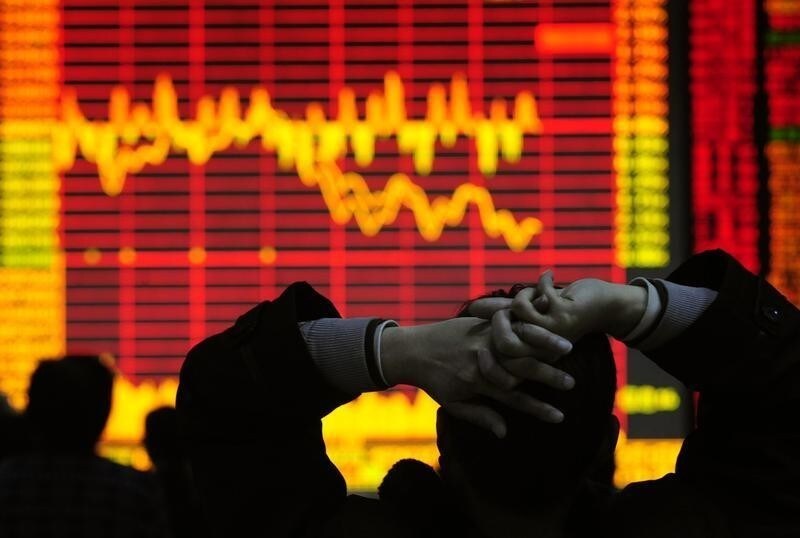 An investor looks at an electronic board showing stock information at a brokerage house in Hefei, Anhui province December 9, 2008. China's stock market dropped in heavy trade on Tuesday, led by property and financial shares, on worries that November economic data, to be released in coming days, would be poor. REUTERS/Stringer (CHINA). CHINA OUT. NO COMMERCIAL OR EDITORIAL SALES IN CHINA. - GF2E4C90PRF01