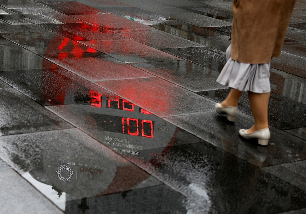 A countdown clock showing that 100 days are left until Tokyo 2020 Olympic Games that have been postponed to 2021 due to the coronavirus disease (COVID-19) pandemic is reflected in a puddle in Tokyo, Japan, April 14, 2021. REUTERS/Issei Kato TPX IMAGES OF THE DAY - RC2KVM9YRJV7