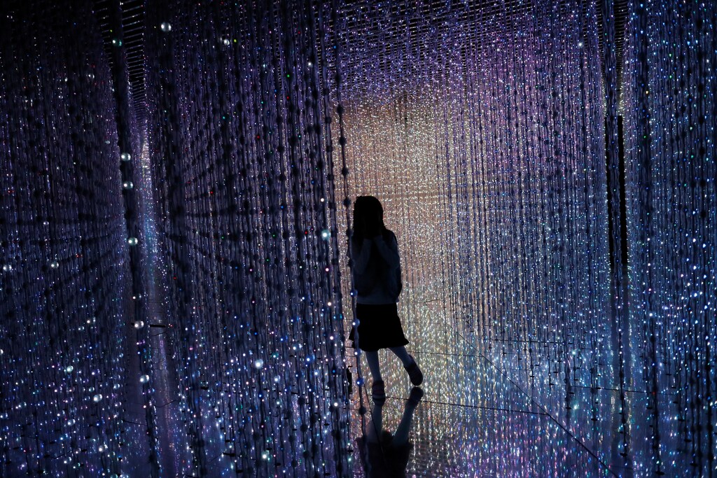 A girl poses at a digital installation which is a part of "Dance! Art Exhibition, Learn & Play!" by Japanese group teamLab in Taipei, Taiwan January 16, 2017. REUTERS/Tyrone Siu - RTSVOMY
