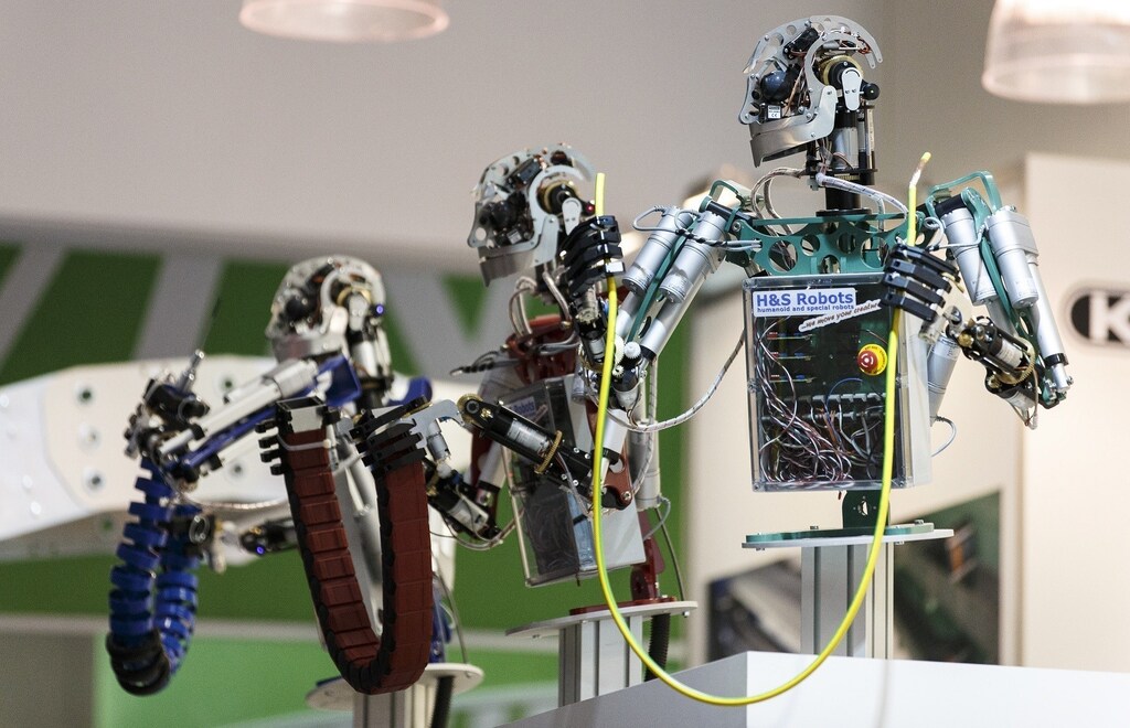 Robots are seen at the "Hannover Messe" industrial trade fair in Hanover April 7, 2014. The world's leading fair for industrial technology, with about 5,000 exhibitors from 65 nations, runs till April 11 with the Netherlands as this year's partner country. REUTERS/Morris Mac Matzen (GERMANY - Tags: SOCIETY BUSINESS) - RTR3K9LK