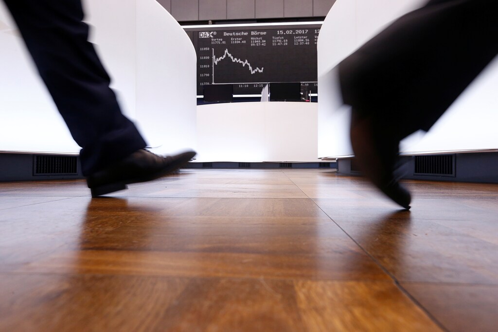 A trader walks past the German DAX Index board on the trading floor at the Frankfurt stock exchange in Frankfurt, Germany, February 15, 2017. REUTERS/Ralph Orlowski - RTSYRR3