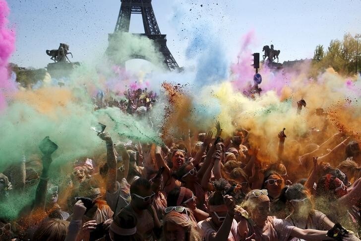 Participants take part in the Color Run near the Eiffel Tower in Paris April 19, 2015. The Color Run is a five-kilometre race, held in cities across the U.S. and also worldwide, with the aim of promoting healthy living and to benefit a charity that organizers choose in each of the cities that the run visits. Participants are doused from head to toe in different colours at each kilometre. REUTERS/Benoit Tessier TPX IMAGES OF THE DAY