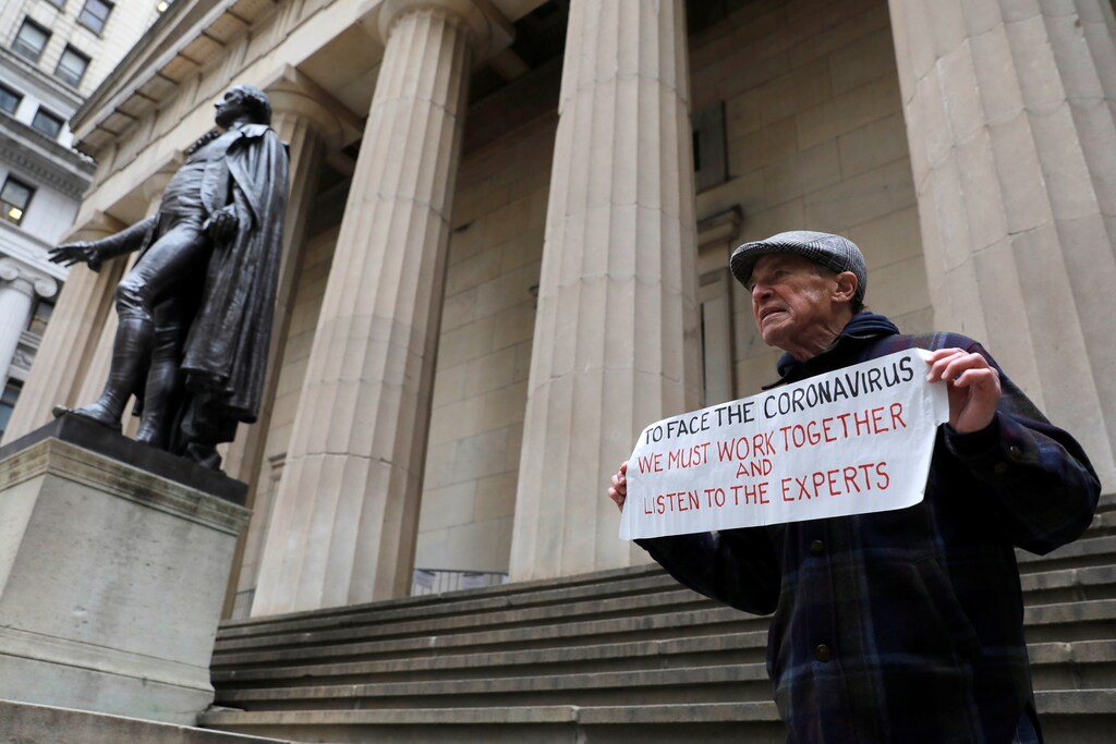 Bill Johnsen of Staten Island, 71, stands on the steps of Federal Hall on Wall Street, after more cases of coronavirus were confirmed in Manhattan, New York City, New York, U.S., March 12, 2020. REUTERS/Andrew Kelly - RC2EIF975IQL