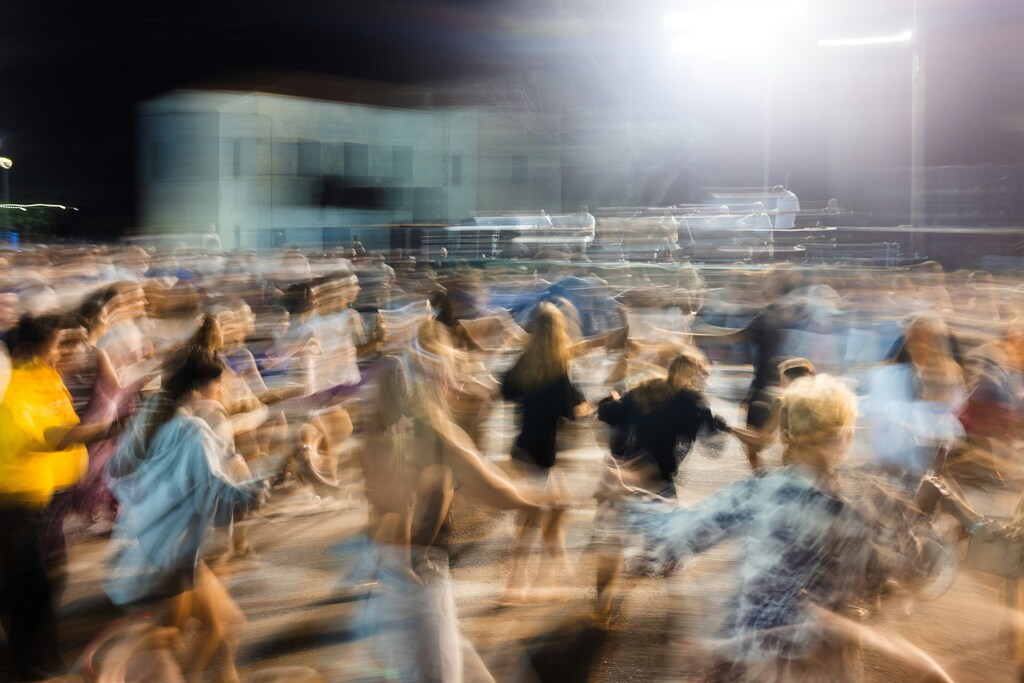 Blurred motion of people joining hands: Collective action is reshaping Canadian philanthropy