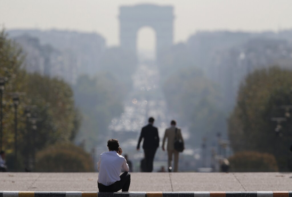 Businessmen are seen on the esplanade of La Defense, in the financial and business district in La Defense, west of Paris, September 19, 2014. Moody's is due to update on France's rating on Friday and a downgrade is widely expected after the government announced last week it would need more time to cut its public deficit.