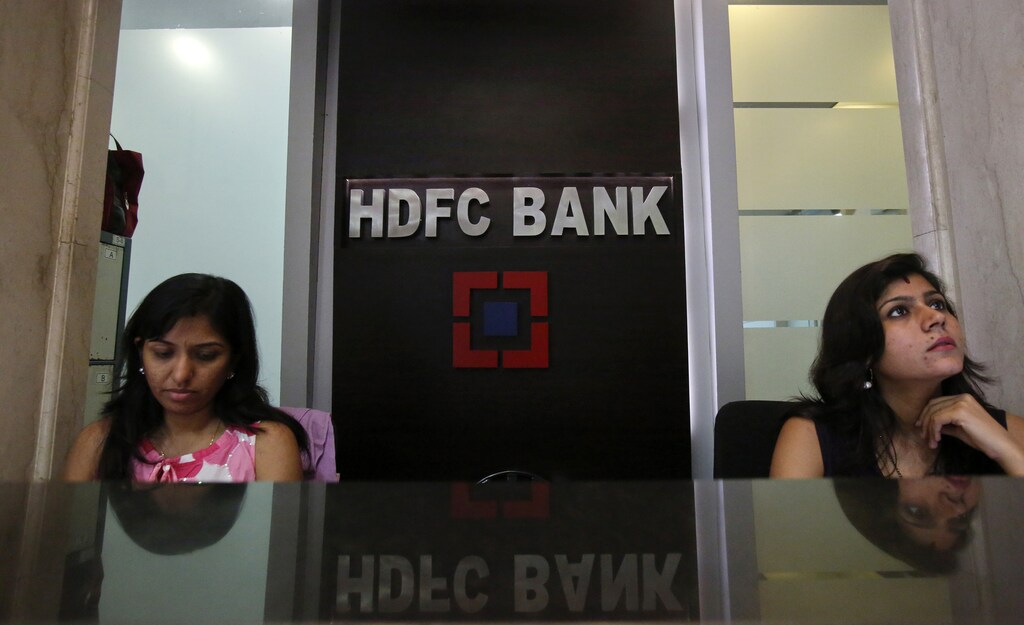 Personal bankers wait for customers at the reception of a HDFC Bank branch in Mumbai November 17, 2012.