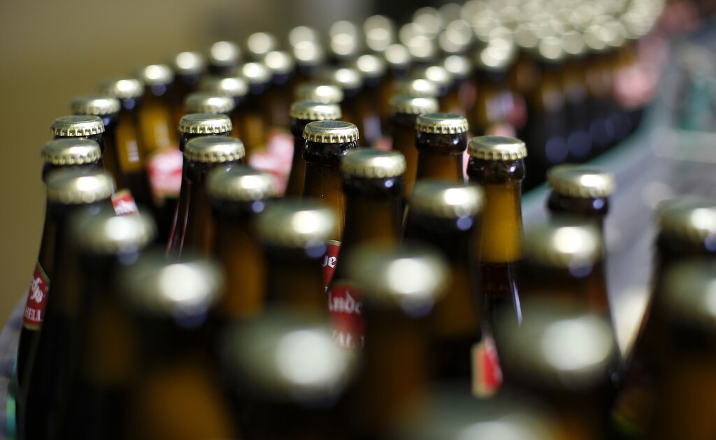 Bottles of beer are transported on a belt at 'Kloster Andechs' brewery in Andechs near Munich, Germany, April 19, 2016. Germany this year marks 500 years of the so-called Reinheitsgebot (purity law), introduced in Bavaria in 1516 to limit the ingredients used in the beer production to hops, barley and water. REUTERS/Michaela Rehle - LR1EC4J12KUIP
