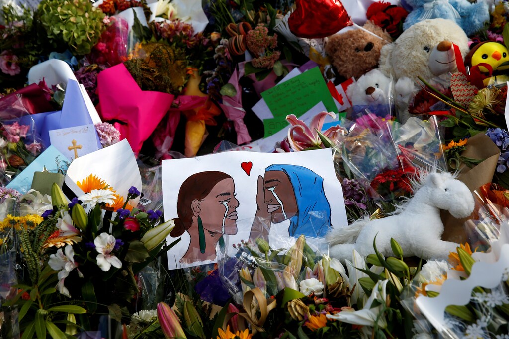 Flowers and cards are seen at the memorial site for the victims of Friday's shooting, outside Al Noor mosque in Christchurch, New Zealand March 19, 2019. REUTERS/Edgar Su - RC1BAB629B00
