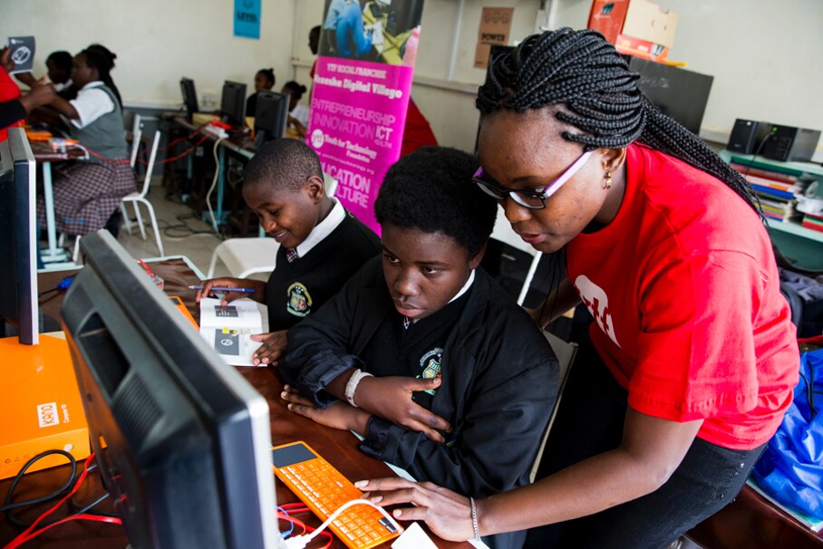 A woman and two boys look at a computer. The Youth for Technology Foundation, run by social innovator Njideka U. Harry, provides programmes, training and opportunities for youth and women in developing nations.