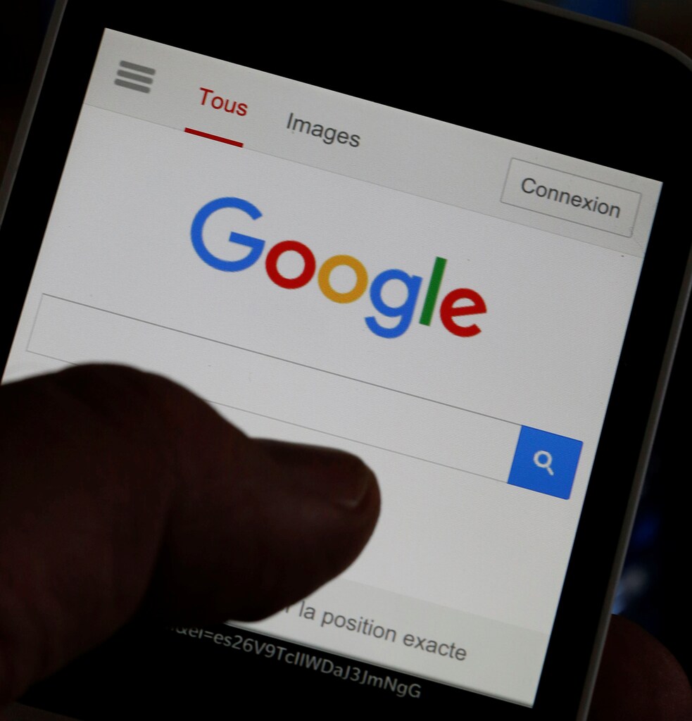 A man holds his smartphone which displays the Google home page, in this picture illustration taken in Bordeaux, Southwestern France, August 22, 2016. REUTERS/Regis Duvignau - RTX2MKQ5