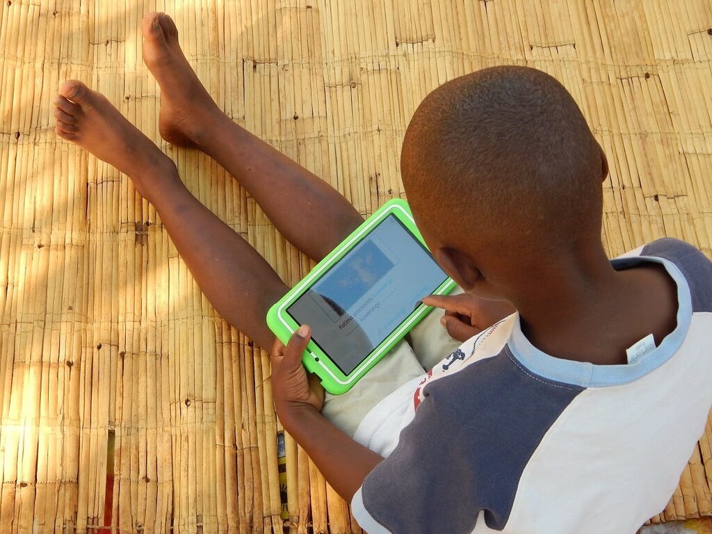 Eight-year-old Elijah Chiseka uses a learning tablet provided by the charity Voluntary Service Overseas in Gumulira village in western Malawi, September 23, 2020.