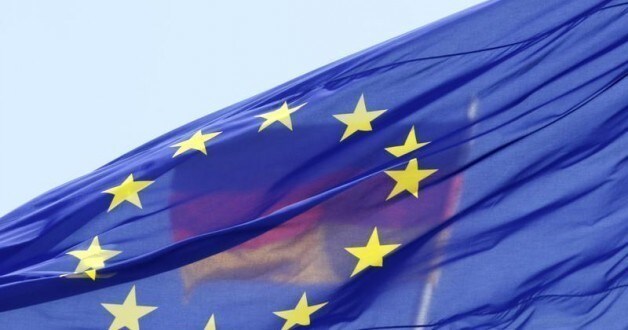 The German national flag is seen behind the EU flag up atop the Reichstag building, seat of the German lower house of parliament Bundestag in Berlin, May 26, 2011.