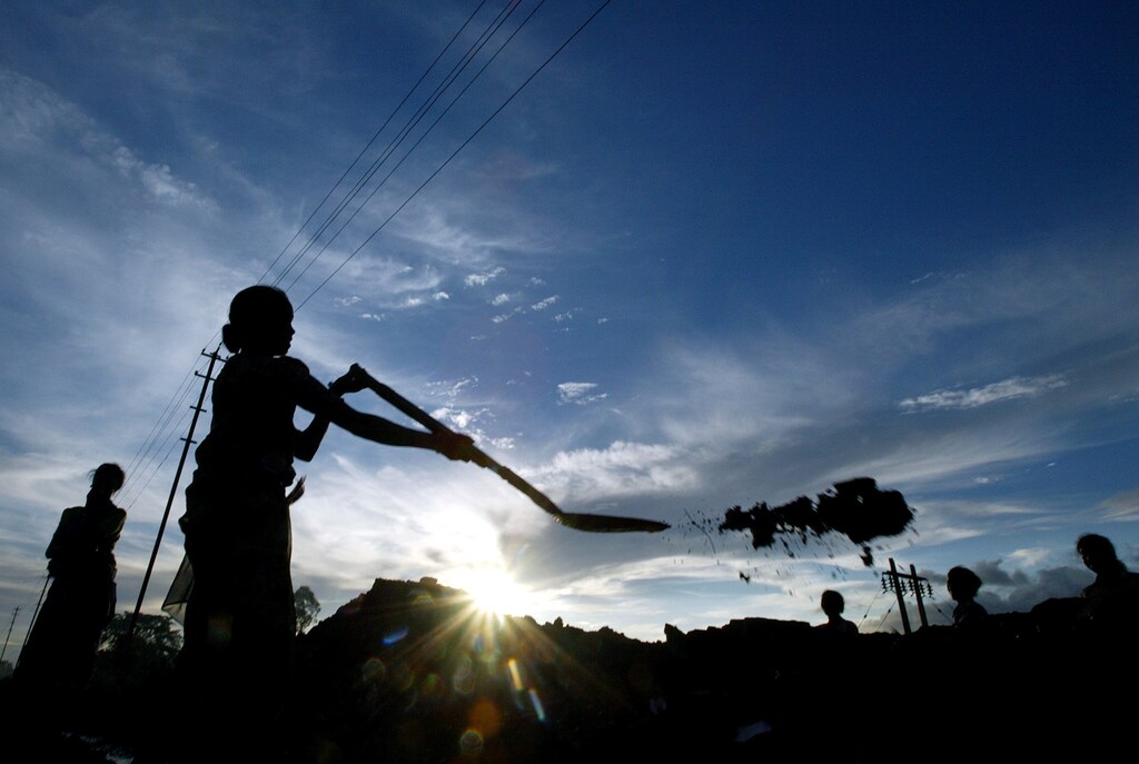 Indian coalmine workers work besides Stilwell road in Lido town, about 600 km (373 miles) from Guwahati, a major city in the northeastern Indian state of Assam, August 19, 2005. Sixty years ago, that road named after U.S. General Joe Stilwell provided a vital lifeline to relieve China's besieged army as it fought Japanese occupation. Today much of Stilwell Road lies disused and overgrown, in parts little more than a jungle track. But it is slowly becoming a symbol of hope, as Beijing and New Delhi repair relations and talk of reopening the road for trade, perhaps as part of a pan-Asian highway. Picture taken August 19, 2005. To match feature India-China-Stilwell. REUTERS/Adnan Abidi AA/VM/mk - RTRNFMH