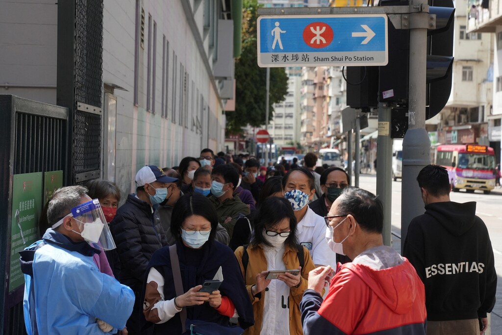 People wearing face masks queue at a makeshift testing centre for the coronavirus disease (COVID-19) following the outbreak in Hong Kong SAR, China, 14 February 2022. REUTERS/Lam Yik