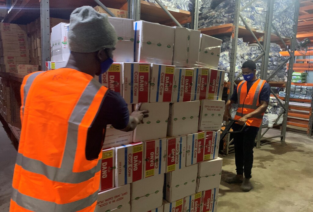 Workers move consumer goods into a Trade Depot warehouse in Lagos, Nigeria August 20, 2020. Picture taken August 20, 2020. REUTERS/Nneka Chile - RC27EJ9AXAHA