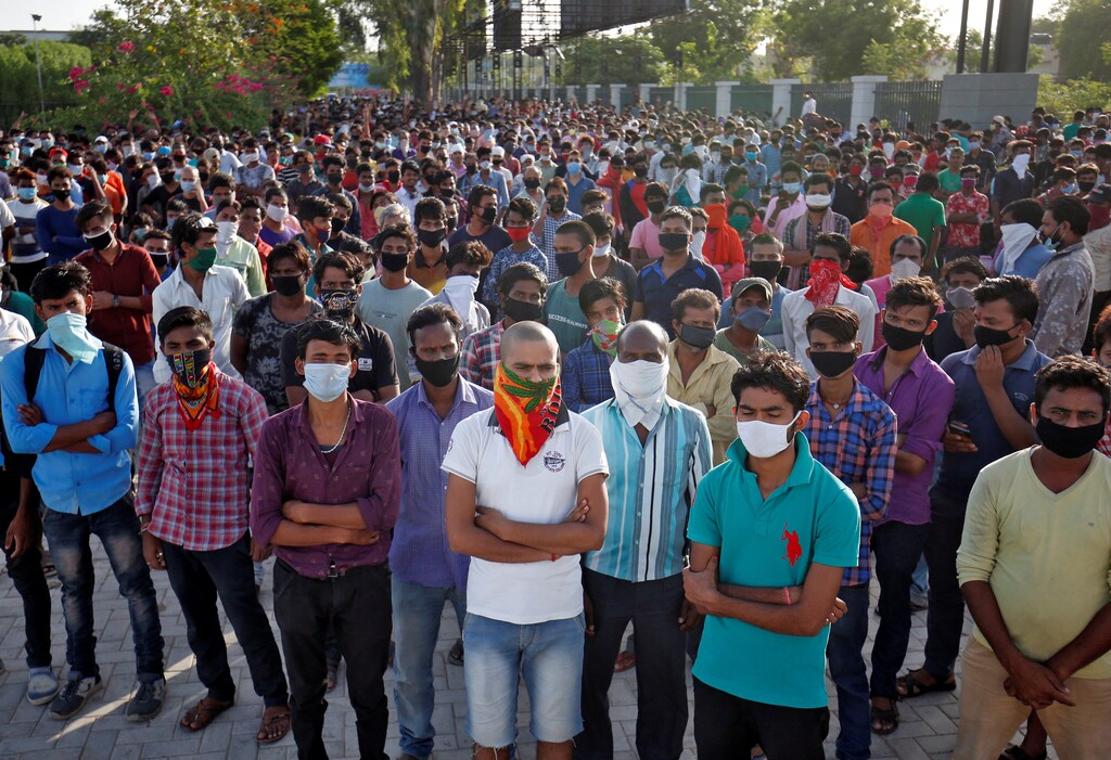 Migrant workers wait for transport to reach a railway station to board a train to their home state of Bihar, during an extended lockdown to slow the spreading of the coronavirus disease (COVID-19), in Ahmedabad, India, May 20, 2020. REUTERS/Amit Dave - RC26SG9BDBBA