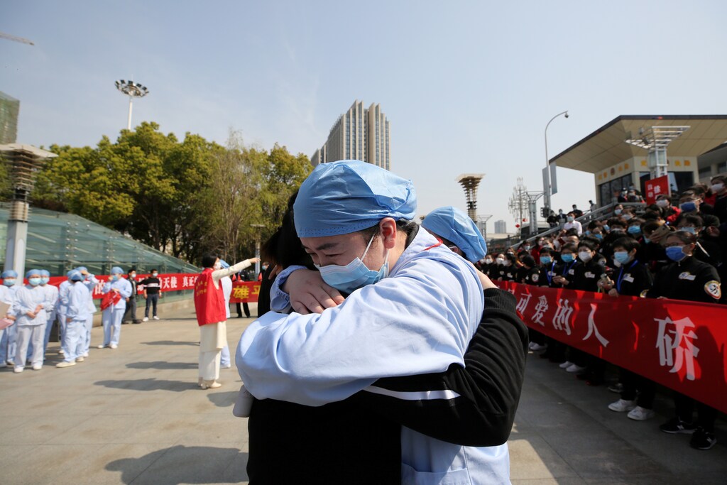 A local medical worker embraces and bids farewell to a medical worker from Jiangsu at the Wuhan Railway Station as the medical team from Jiangsu leaves Wuhan, the epicentre of the coronavirus disease (COVID-19) outbreak, in Hubei province, China Coronavirus china virus health healthcare who world health organization disease deaths pandemic epidemic worries concerns Health virus contagious contagion viruses diseases disease lab laboratory doctor health dr nurse medical medicine drugs vaccines vaccinations inoculations technology testing test medicinal biotechnology biotech biology chemistry physics microscope research influenza flu cold common cold bug risk symptomes respiratory china iran italy europe asia america south america north washing hands wash hands coughs sneezes spread spreading precaution precautions health warning covid 19 cov SARS 2019ncov wuhan sarscow wuhanpneumonia pneumonia outbreak patients unhealthy fatality mortality elderly old elder age serious death deathly deadly