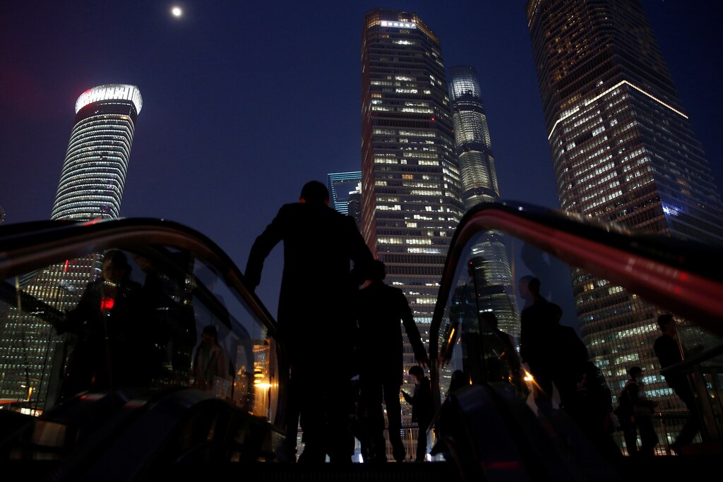 People walk in the financial district of Pudong in Shanghai, China March 9, 2017. REUTERS/Aly Song - RTS124PB