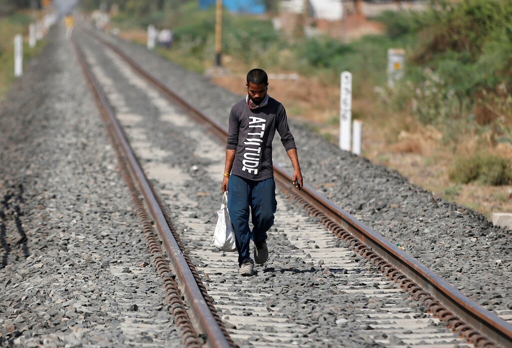 A migrant worker walks along a railway track to return to his home state of central Madhya Pradesh, during an extended nationwide lockdown to slow the spreading of the coronavirus disease (COVID-19), in Ahmedabad, India, May 19, 2020