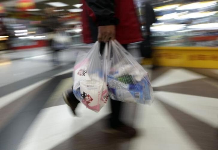 A customer carries bags of salt as he leaves a supermarket in central Beijing March 17, 2011. Residents in some Chinese cities flocked to buy iodized salt, as many of them believed it could help ward off potential radiation effects as a result of Japan's crippled nuclear power plant following a deadly earthquake and tsunami, local media reported.REUTERS/Jason Lee (CHINA - Tags: SOCIETY DISASTER FOOD)