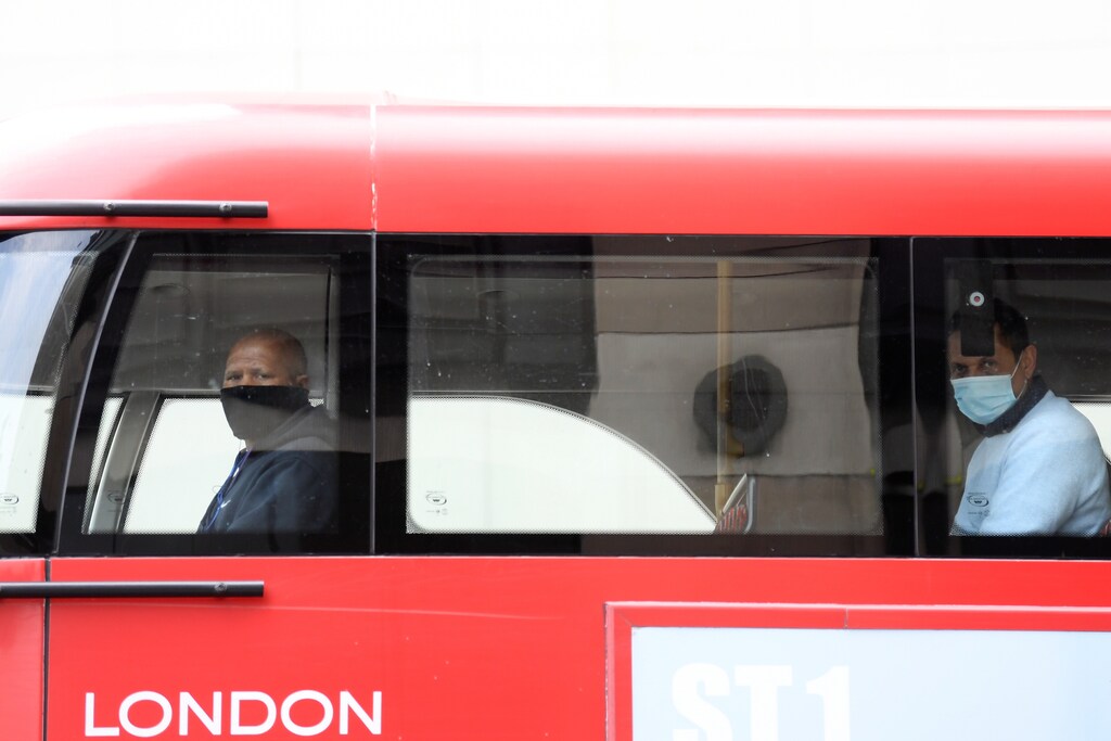 Two passengers wearing masks are seen on a bus in Central London, as the spread of the coronavirus disease (COVID-19) continues, London, Britain, April 17, 2020. REUTERS/Toby Melville - RC2B6G9AHCA3