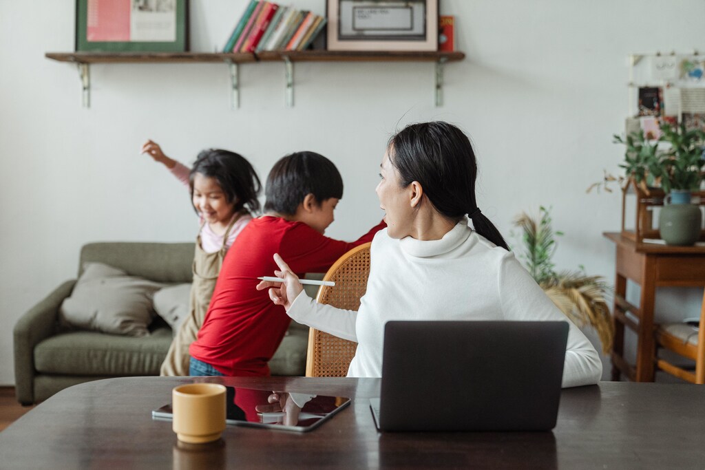 Mother trying to work with kids at home.
