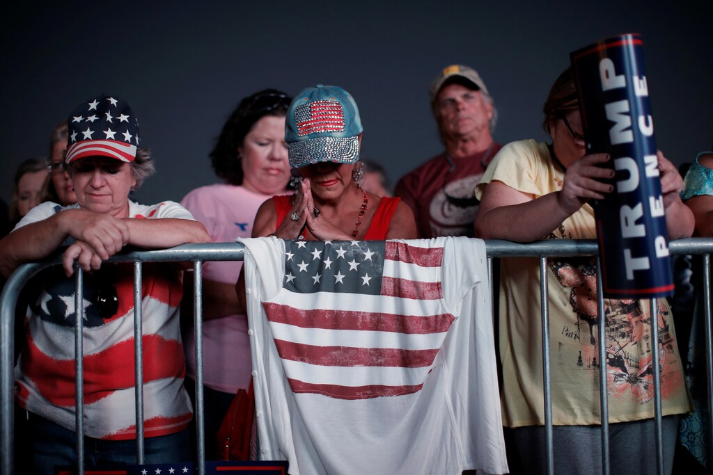 Supporters of Republican U.S. presidential nominee Donald Trump bow their heads in prayer at a campaign rally in Panama City, Florida, U.S., October 11, 2016. REUTERS/Mike Segar - RTSRULK